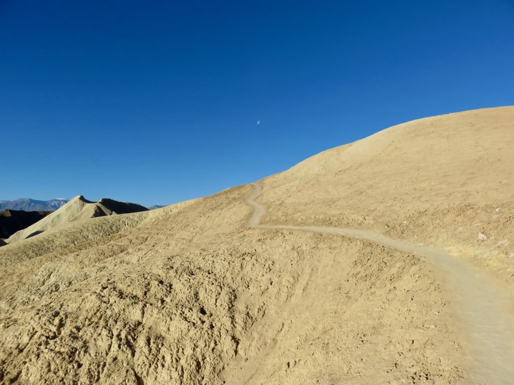 Trail climbs a hill in the badlands